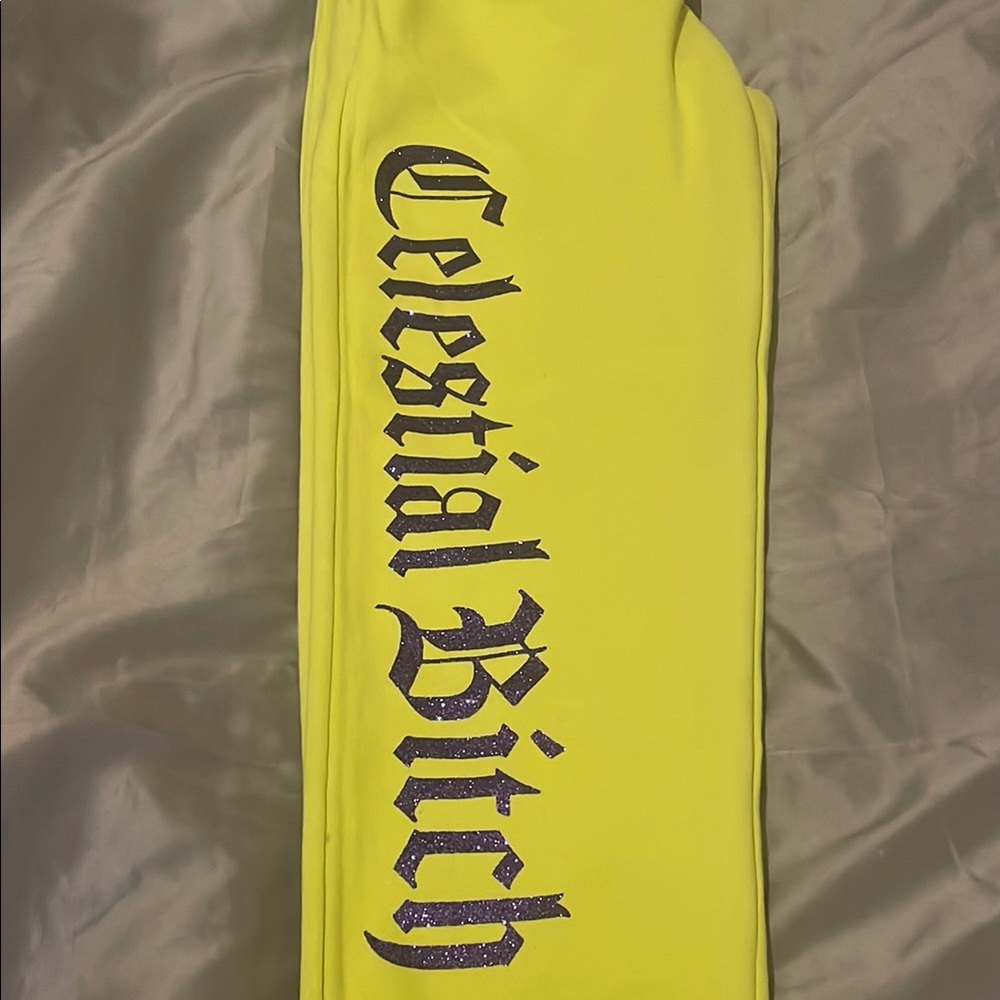 Women’s sweat pants. Bright green or yellow With purple glitter letters.